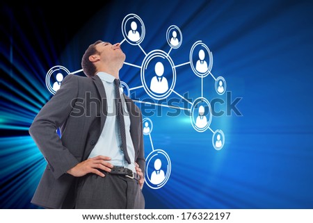 Cheerful businessman with hands on hips against digital earth background