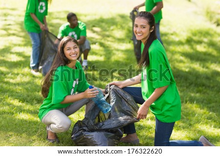 Team Of Young Volunteers Picking Up Litter In The Park