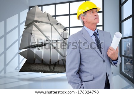 Mature architect taking a close look against room with large window showing city