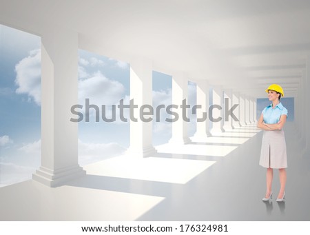 Smiling attractive architect posing against bright white hall with columns