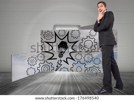 Thinking businessman touching chin against open door leading to bright window