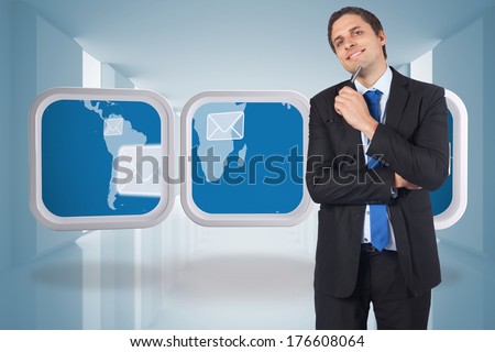 Thinking businessman holding pen against lit up white modern hallway