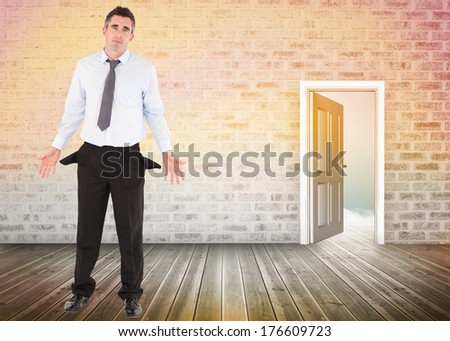 Businessman with empty pockets against door opening showing blue sky
