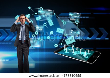 Stressed businessman with hands on head against arrows on technical background