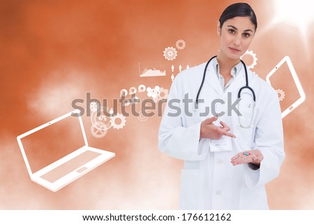 Female doctor pointing at pill in her hand against file transfer background