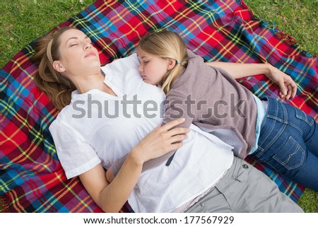 Elevated view of a relaxed mother and daughter lying at the park