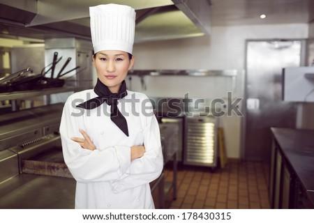Portrait of a confident female cook standing in the kitchen