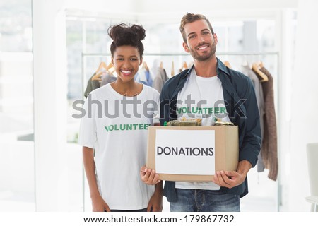 Portrait of a smiling young couple with clothes donation