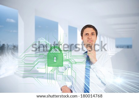 Digital composite of confused businessman with lock and circuit board graphic