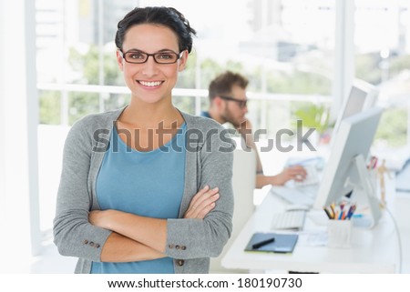 Young attractive designer smiling at camera in creative office Young attractive designer smiling at camera in creative office