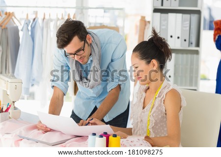 Male and female fashion designers at work in a studio