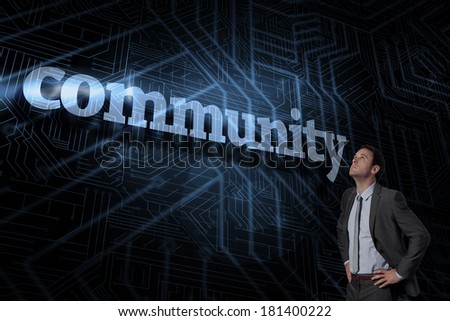 The word community and serious businessman with hands on hips against futuristic black and blue background