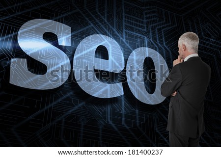 The word seo and thoughtful businessman standing back to camera against futuristic black and blue background