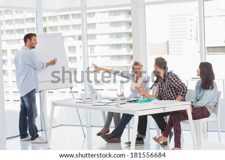 Man presenting an idea to his colleagues in creative office