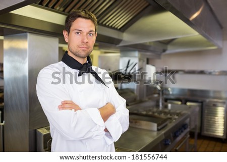 Portrait of a serious male cook with arms crossed standing in the kitchen