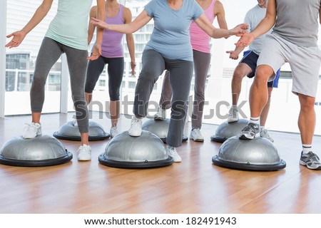 Low section of people doing power fitness exercise at yoga class