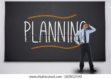 Businessman thinking against the word planning