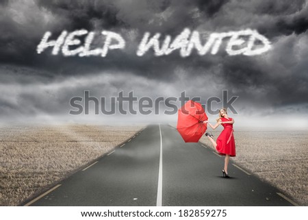 The word help wanted and beautiful woman posing with a broken umbrella against misty brown landscape with street