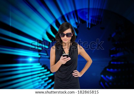 Digital composite of glamorous brunette using smartphone against blue technology background