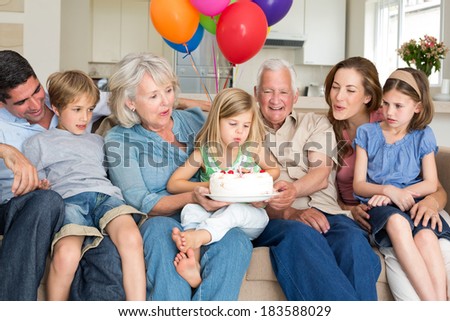 Multigeneration family celebrating girls birthday at home