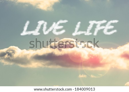 The word live life against bright blue sky with cloud
