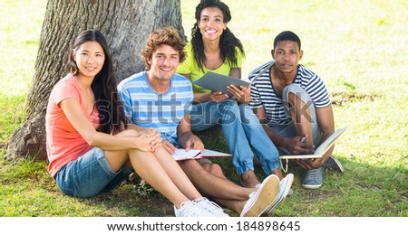 Portrait of happy university students studying together on college campus