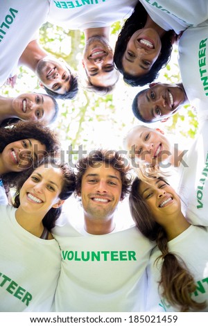 Low angle portrait of multiethnic environmentalists forming huddle