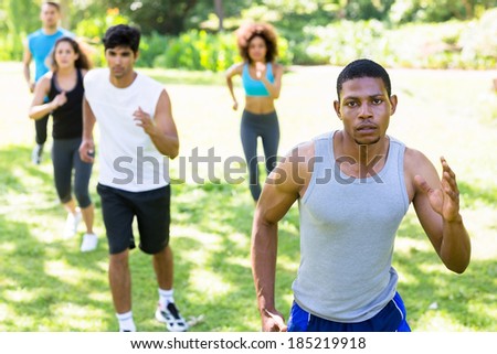 Group of multiethnic people running for fitness in the park