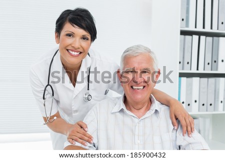 Portrait of a female doctor with happy senior patient at the hospital