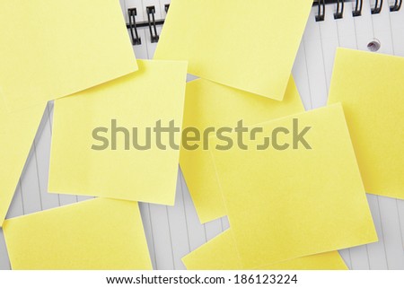Sticky notes strewn over notepad paper
