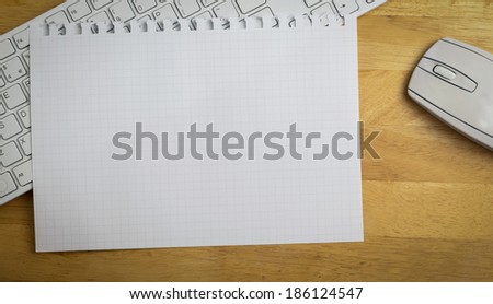Overhead of graph paper on keyboard on a desk