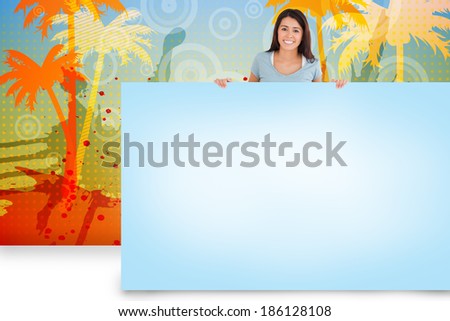 Composite image of pretty brunette showing blue card