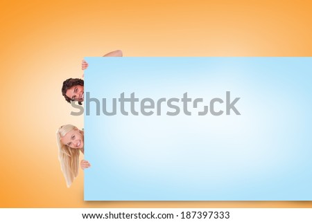 Composite image of attractive couple showing blue card