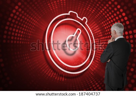 Composite image of stopwatch and businessman looking against red pixel spiral
