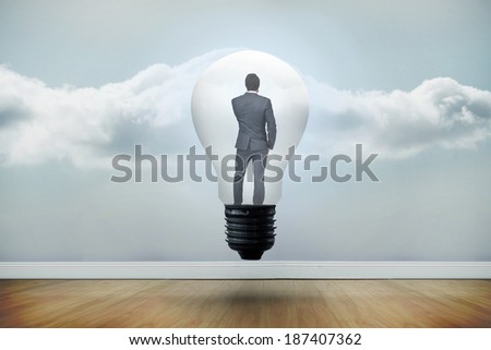 Thinking businessman in light bulb against clouds in a room