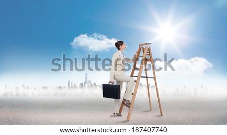 Businesswoman climbing career ladder with briefcase against cityscape on the horizon
