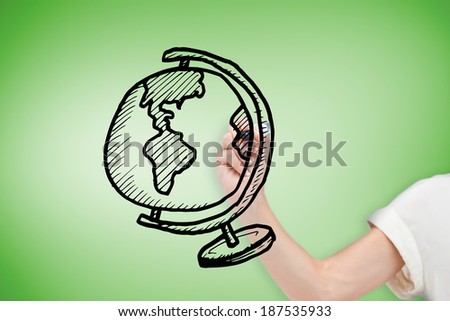 Composite image of businesswoman drawing globe against green vignette