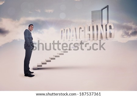 The word coaching and smiling businessman standing against white steps leading to open door