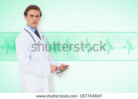 Young doctor using tablet pc against green medical background with ecg line