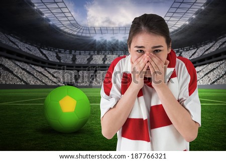 Nervous football fan looking ahead against vast football stadium with fans in white