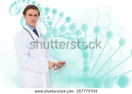 Young doctor using tablet pc against blue medical background with dna