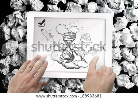 Composite image of hand touching tablet showing hourglass doodle