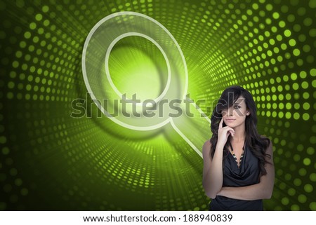 Composite image of magnifying glass and sexy brunette against green pixel spiral