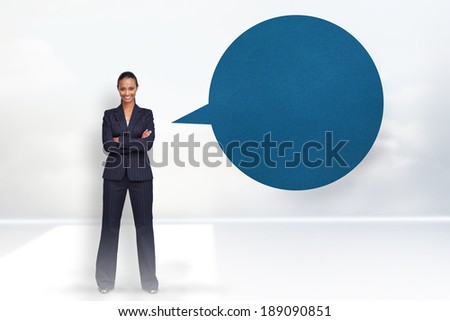 Confident businesswoman smiling at the camera with speech bubble against clouds in a room