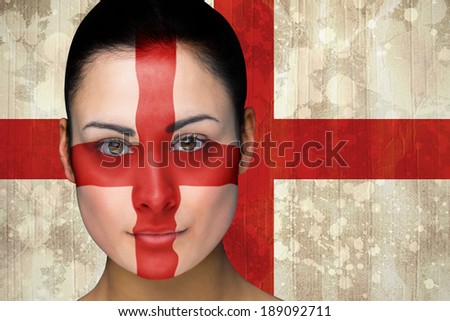 Composite image of beautiful england football fan in face paint against england flag in grunge effect