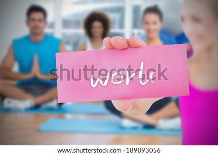Fit blonde holding card saying work against yoga class in gym