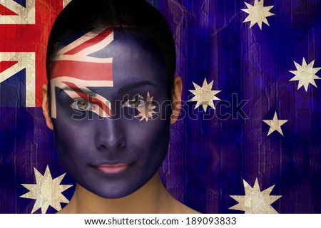 Composite image of beautiful football fan in face paint against australia flag in grunge effect