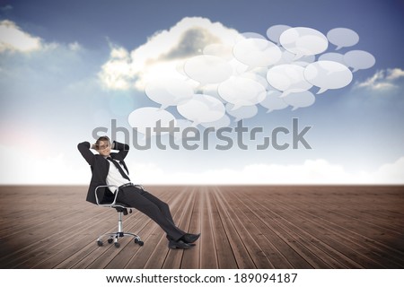 Composite image of businessman sitting on swivel chair against cloudy sky background