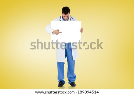 Young doctor showing card against yellow vignette