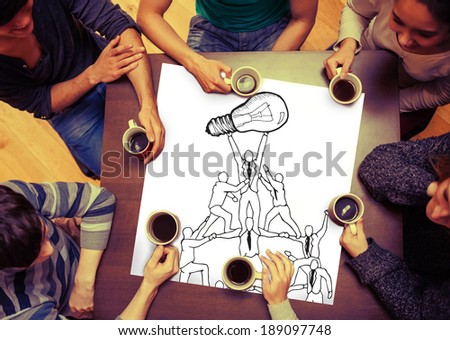 Composite image of team holding up light bulb on page with people sitting around table drinking coffee